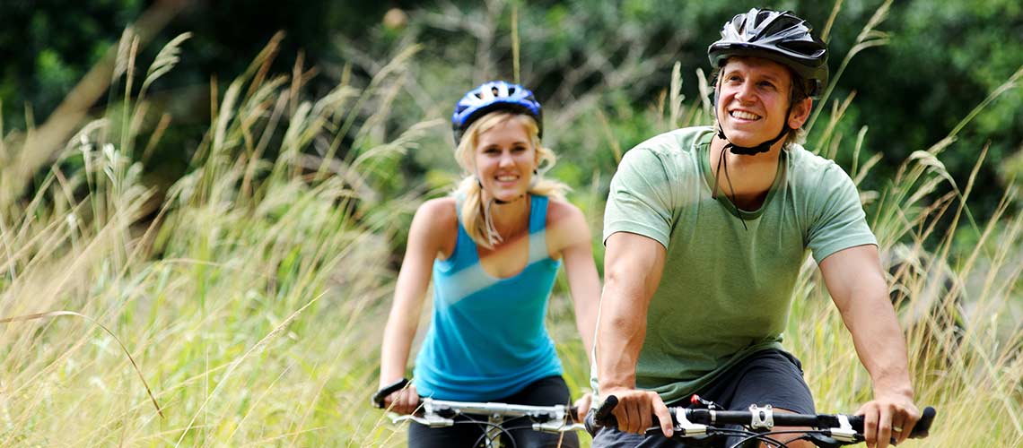 Couple cycling looking happy